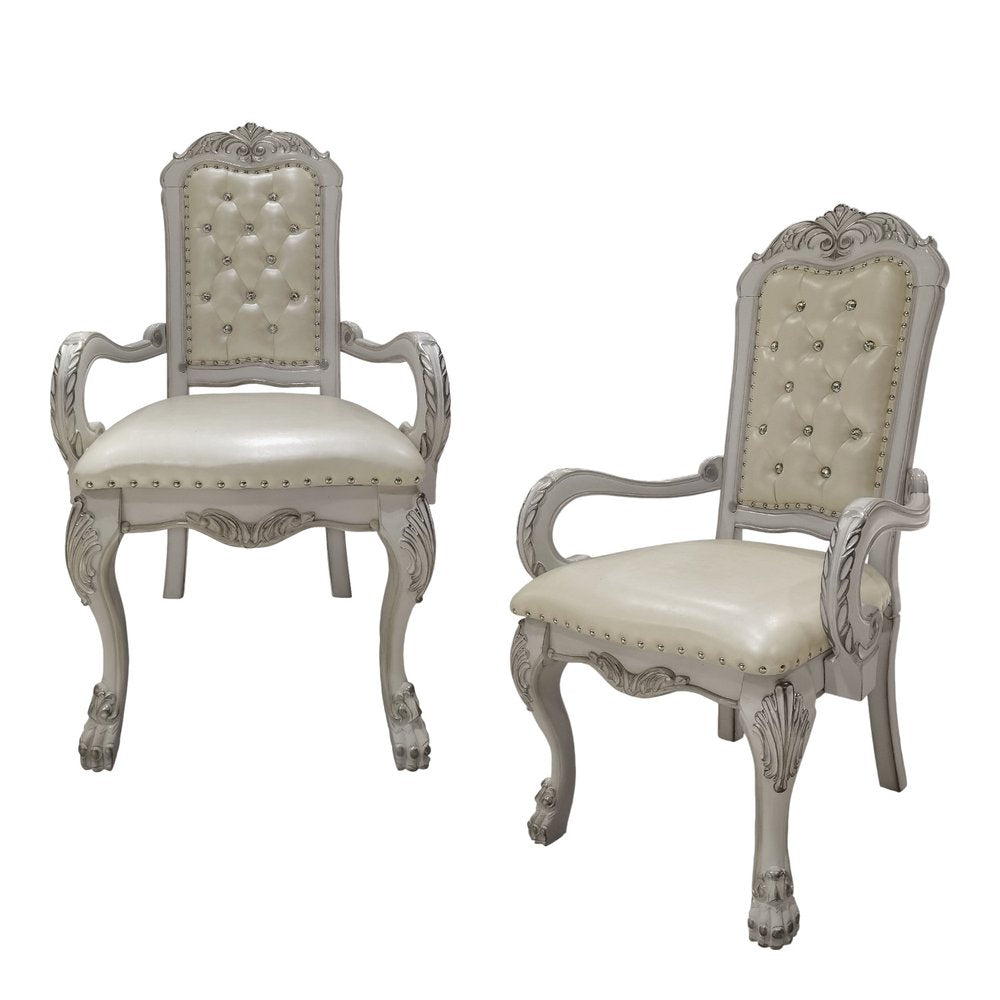 Set of Two Tufted White Upholstered Faux Leather And Wood Dining Arm Chairs on a white background