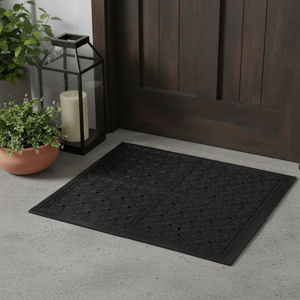 Set Of Four Square Interlocking Black Rubber Indoor Outdoor Mats in a home interior