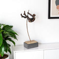 15" Bronze Resin Pole Vaulting Man Tabletop Sculpture. Sculpture isolated on a plain white background, showing a resin surface.