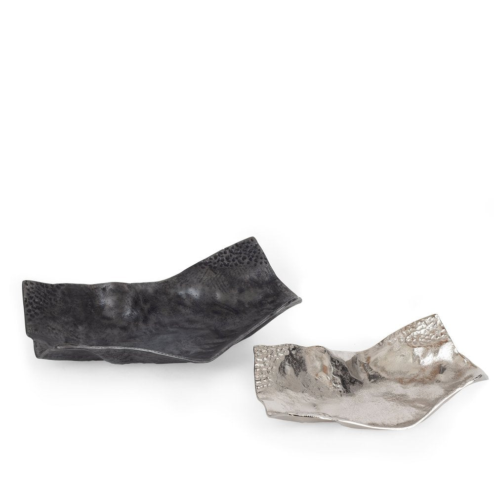 Two abstract aluminum vanity trays, one black and one silver, on a white background.