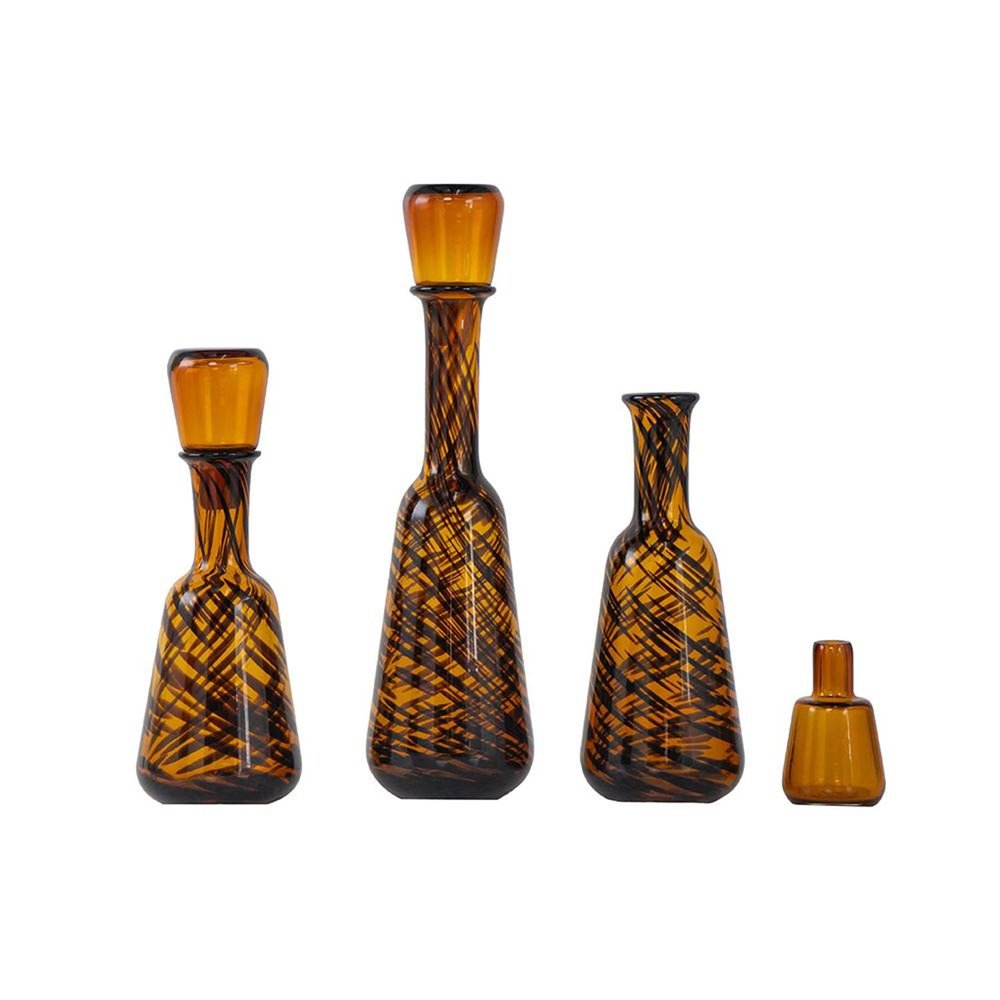 Set of Three Amber Abstract Swirl Glass Decorative Bottles With Stoppers on a white background