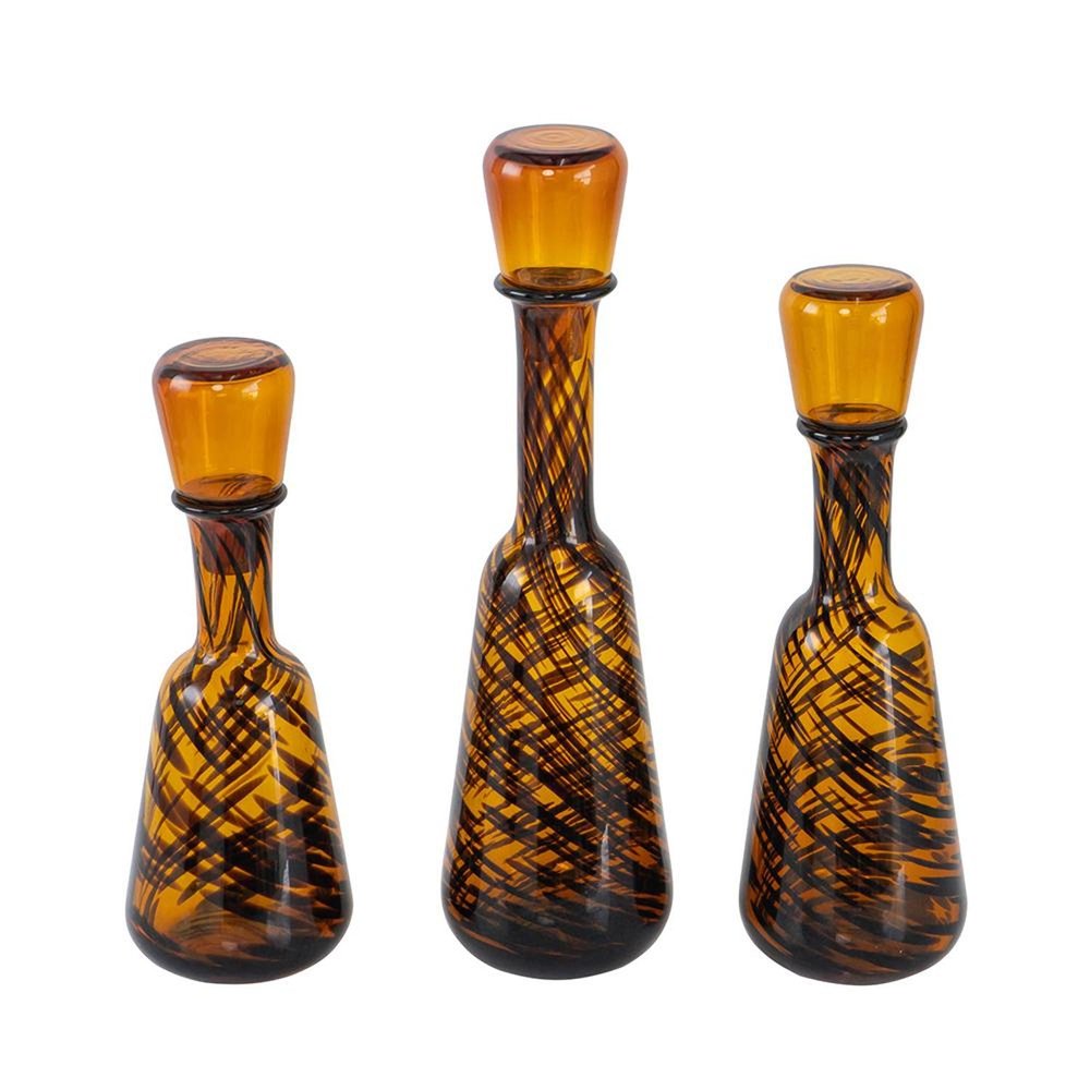 Set of Three Amber Abstract Swirl Glass Decorative Bottles With Stoppers on a white background