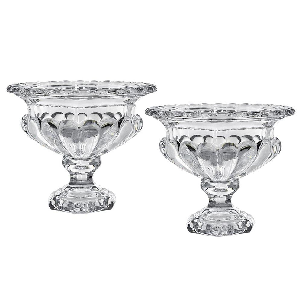 Two clear glass footed bowls with decorative rims and fluted sides on a white background.