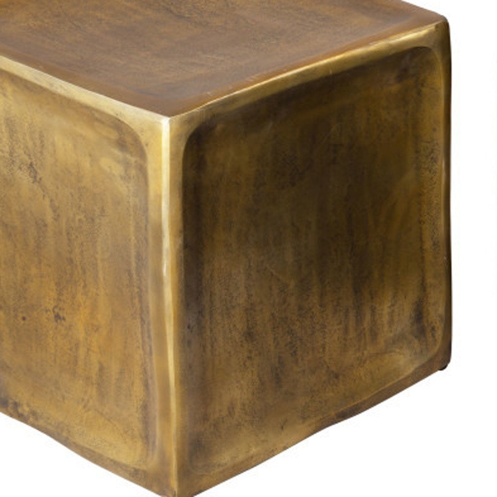 Close-up of an antiqued brass aluminum square block end table with a textured finish on a white background.