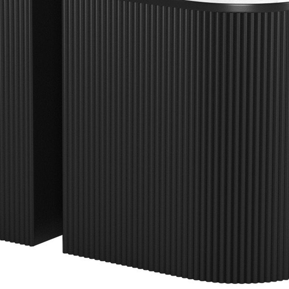 Black fluted oval end table with a white marble top, shown next to another black end table.