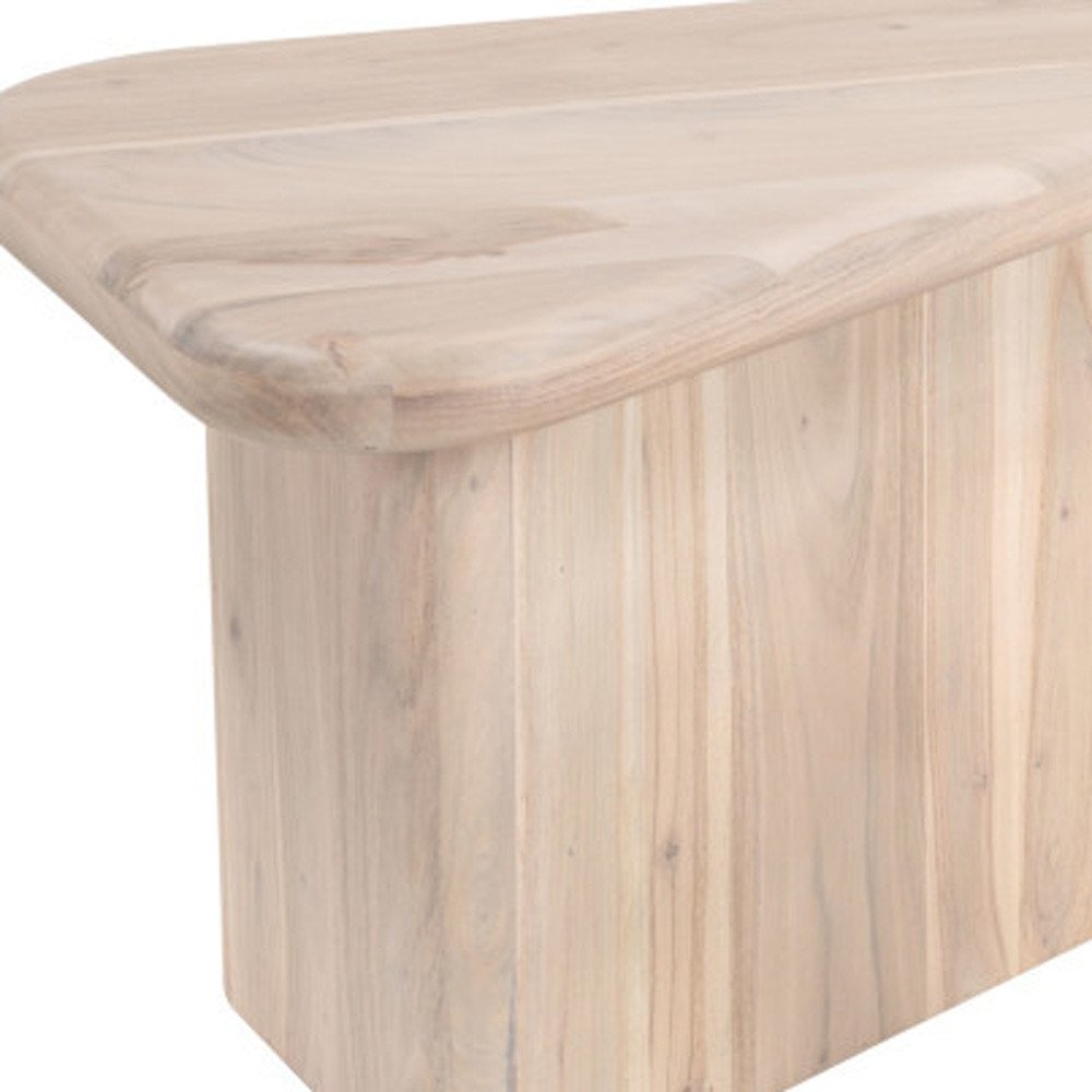 Close-up of a light wood coffee table with a rounded edge and vertical wood grain on the pedestal.