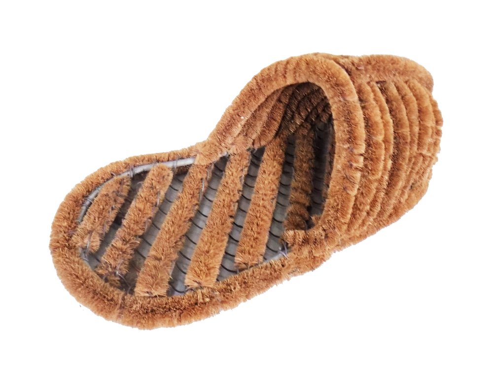 Brown coir boot scraper with ribbed texture and black interior, isolated on white background.