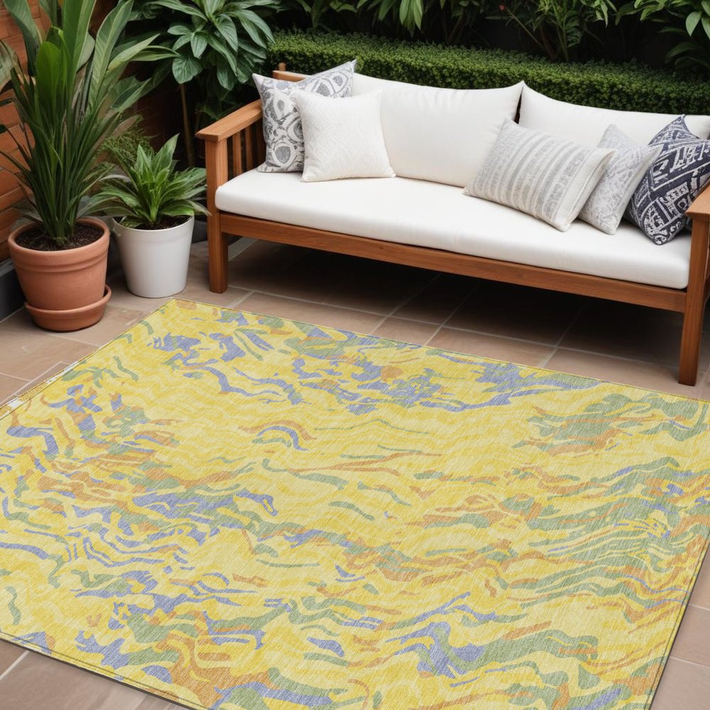 9' X 12' Yellow Purple And Green Abstract Washable Indoor Outdoor Area Rug in a home interior