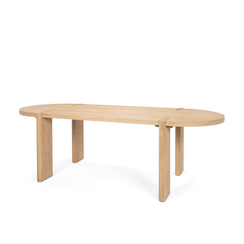 Light brown wood oval dining table with unique leg design on a white background.