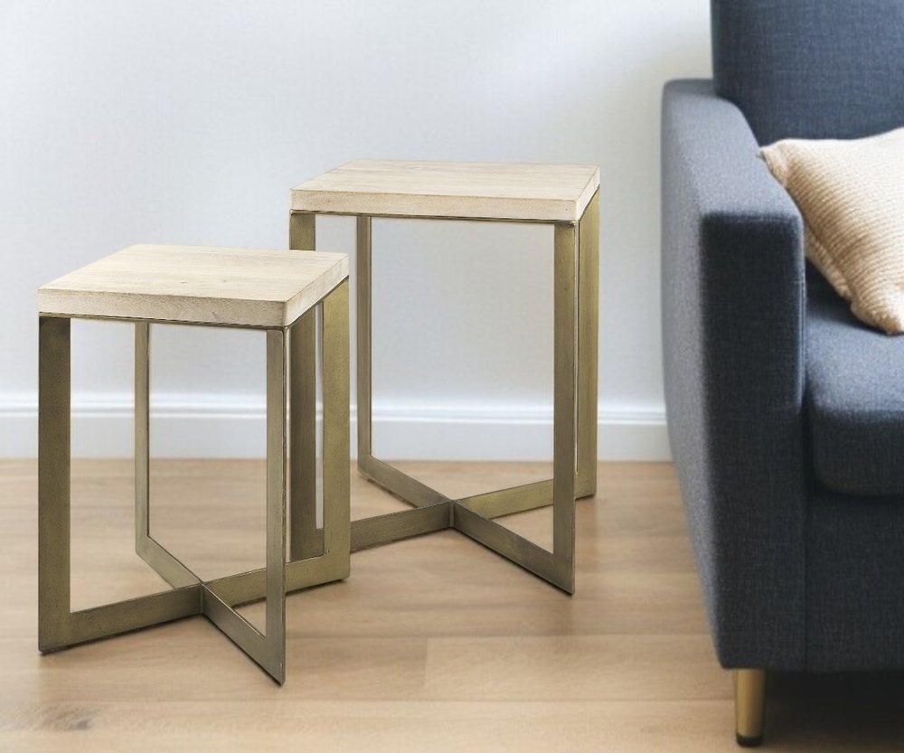 Set of Two Natural and Gold Solid Wood and Metal Square Cross Legs Nested Tables in a home interior