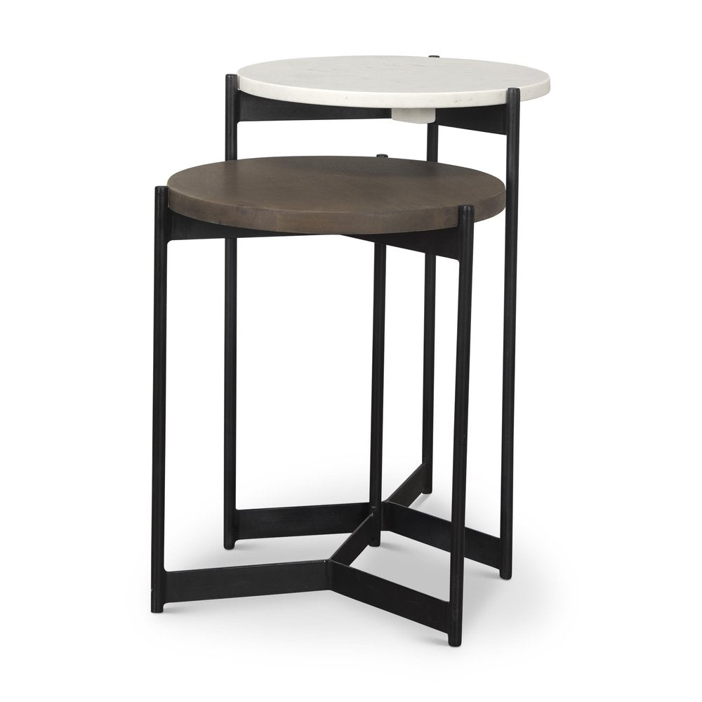 Set of two round nested tables, one with a dark brown solid wood top and the other with a white marble top, on black metal bases.