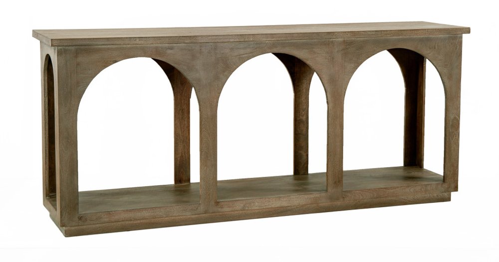 A long, narrow, distressed brown solid wood console table with four arched openings and a shelf.