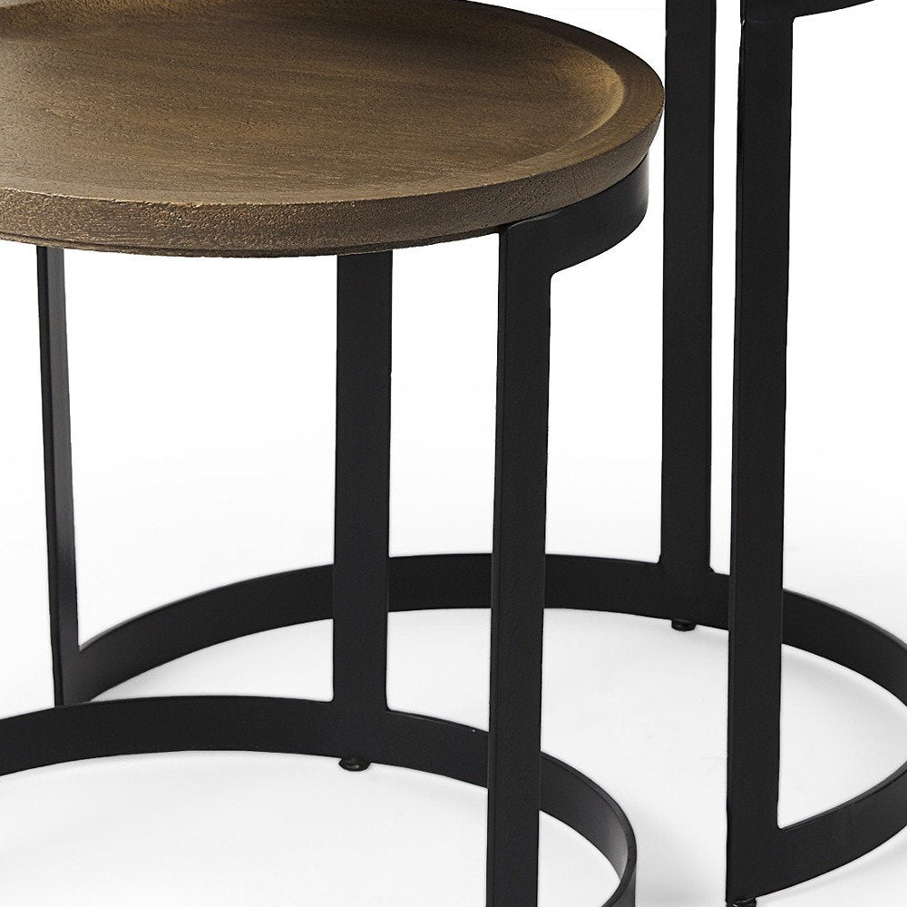 Set of Two Brown and Black Solid Wood and Iron Round Nested Tables on a white background