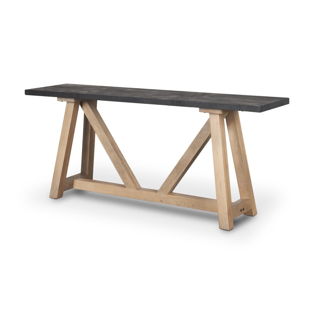 A black solid wood trestle console table with a light brown wood base on a white background.