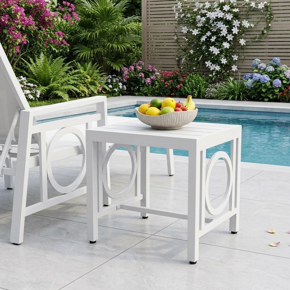 16" White Metal Outdoor Side Table shown outdoors on a patio with greenery.