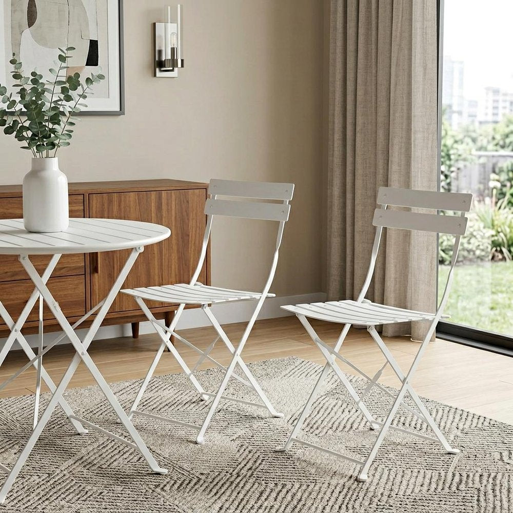 Set of Two White Aluminum Outdoor Folding Dining Chairs in a home interior