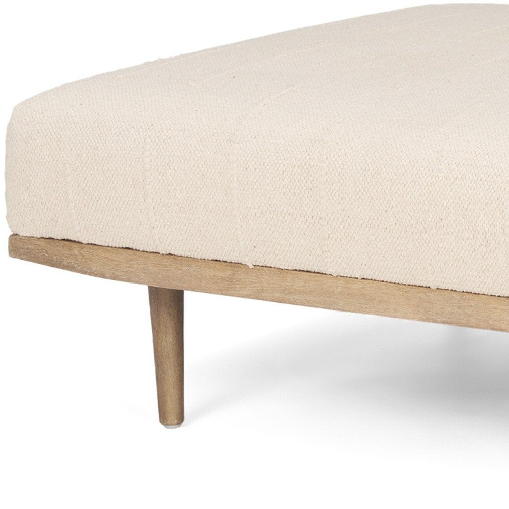 37" Beige and Brown Solid Wood and Fabric Ottoman. Ottoman isolated on a plain white background, showing a beige wood surface.