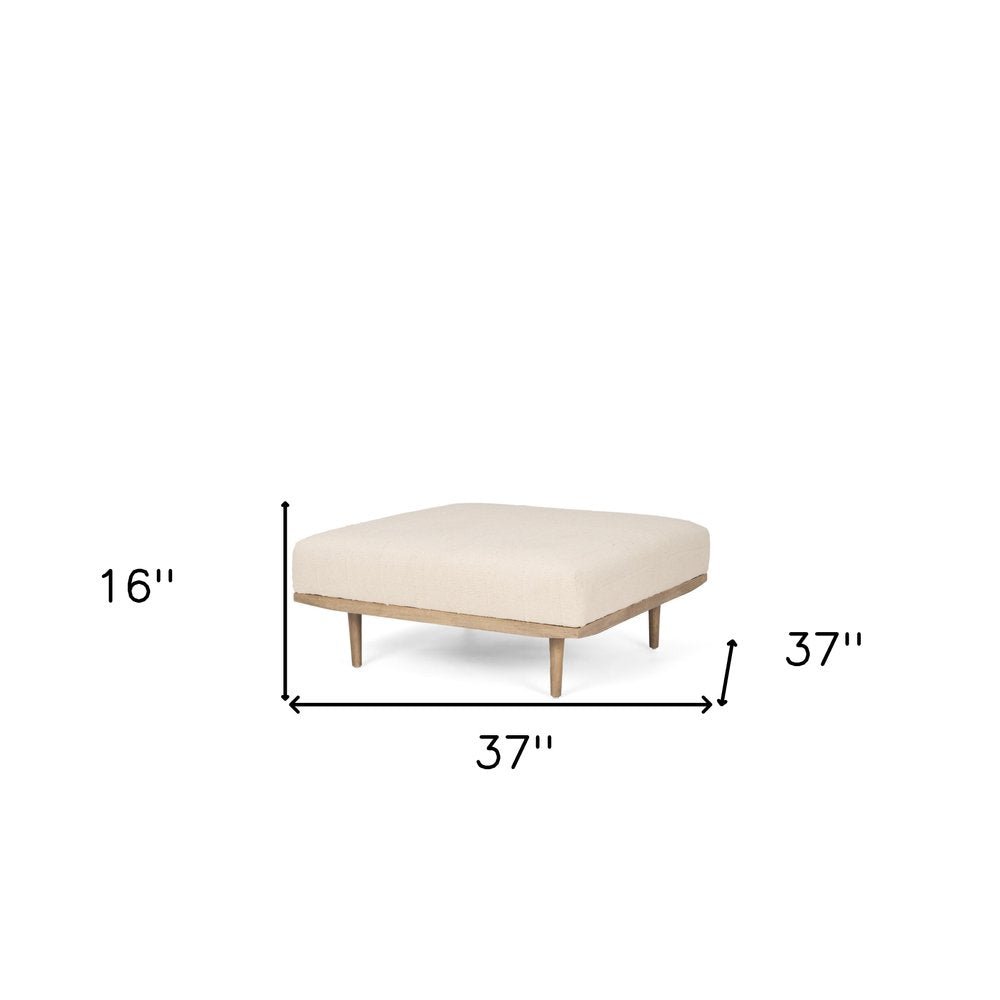 37" Beige and Brown Solid Wood and Fabric Ottoman. Ottoman isolated on a plain white background, in a beige wood finish.