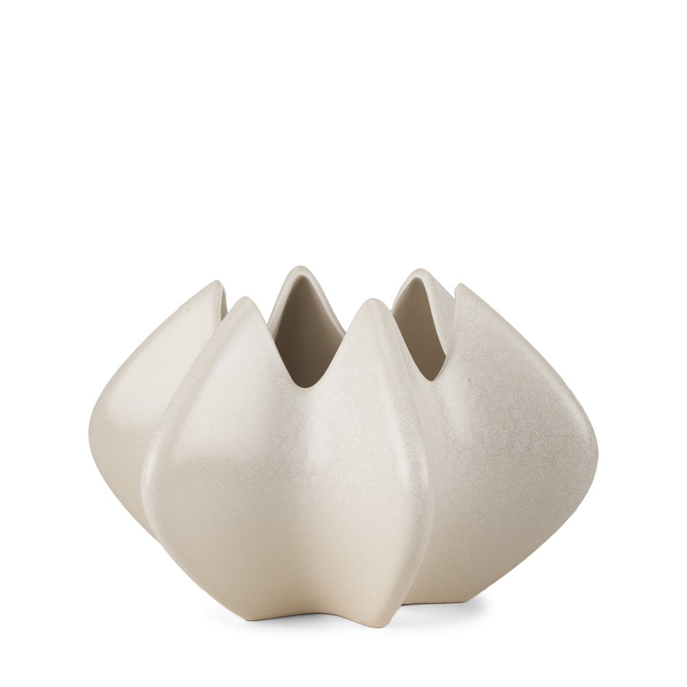 A cream-colored sculptural ceramic vase with a speckled finish on a white background.