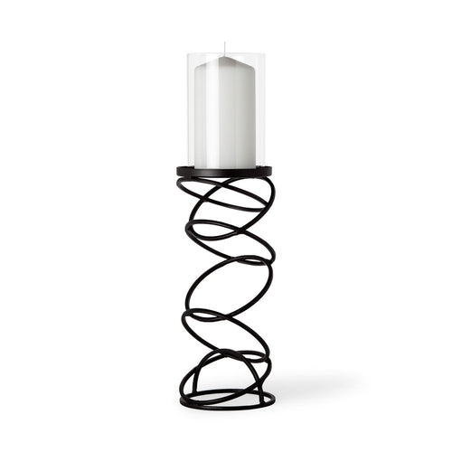 Black metal spiral tabletop candle holder with a clear glass cylinder holding a white pillar candle on a white background.