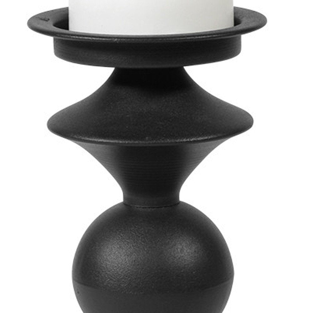 13" Black Metal Tabletop Pillar Candle Holder. Candle holder isolated on a plain white background, showing a black metal surface.