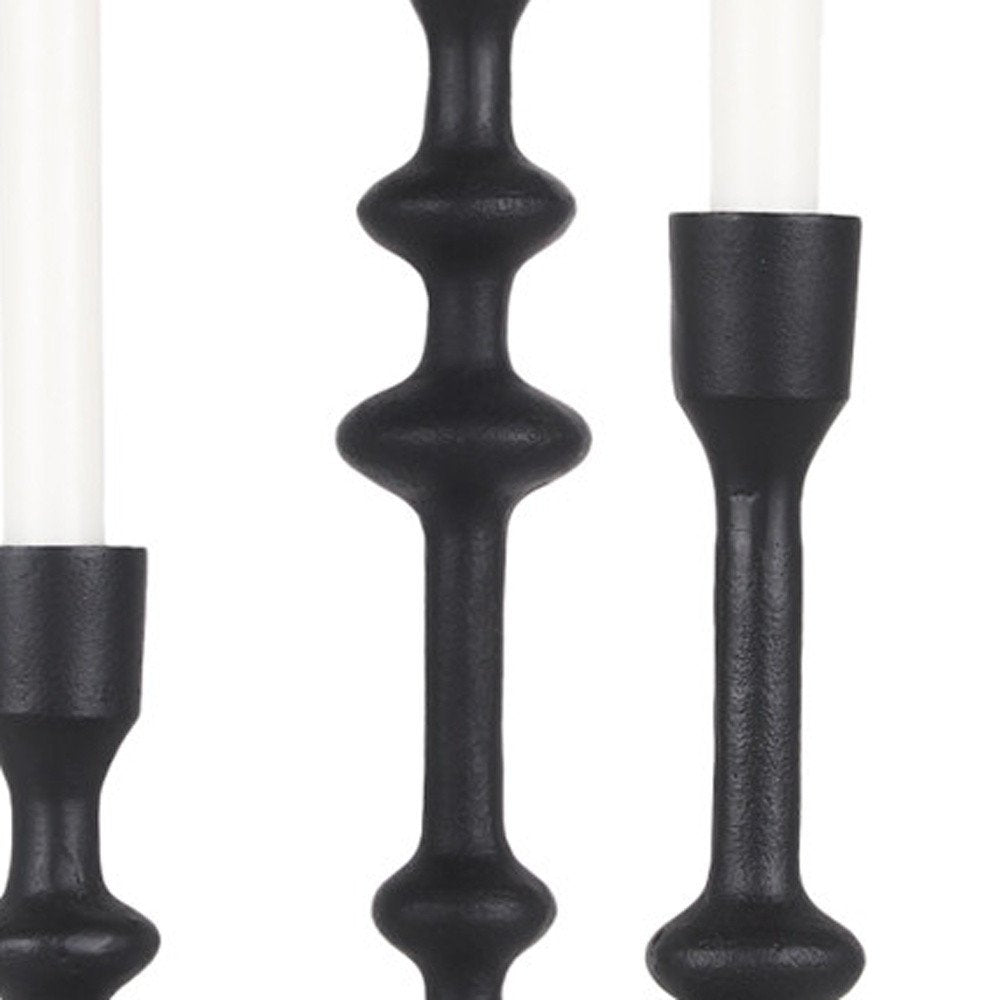Set of Three Black Geometric Metal Tabletop Taper Candlesticks on a white background