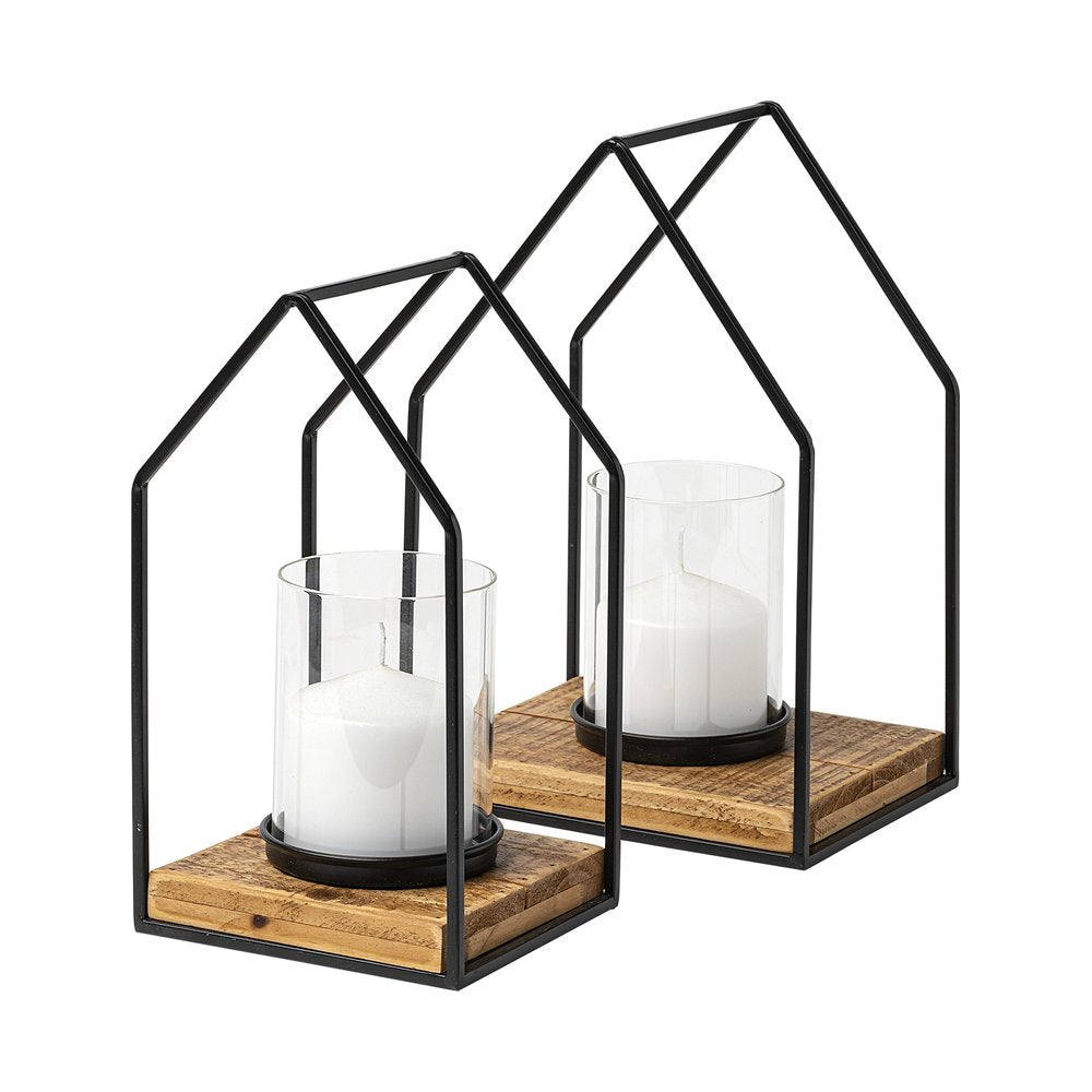 Two black metal geometric lantern candle holders with glass cylinders and distressed wood bases on a white background.