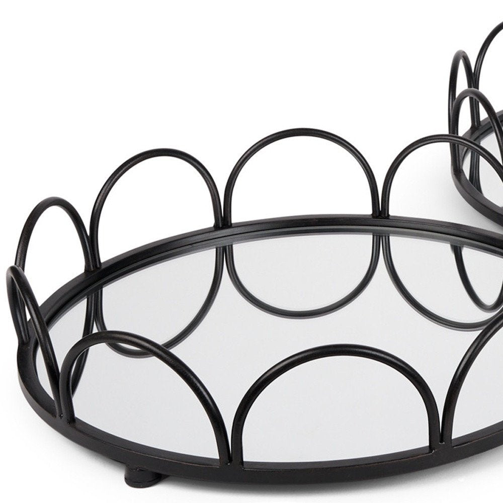 Set of Two Black And Silver Metal And Mirrored Glass Round Vanity Trays on a white background