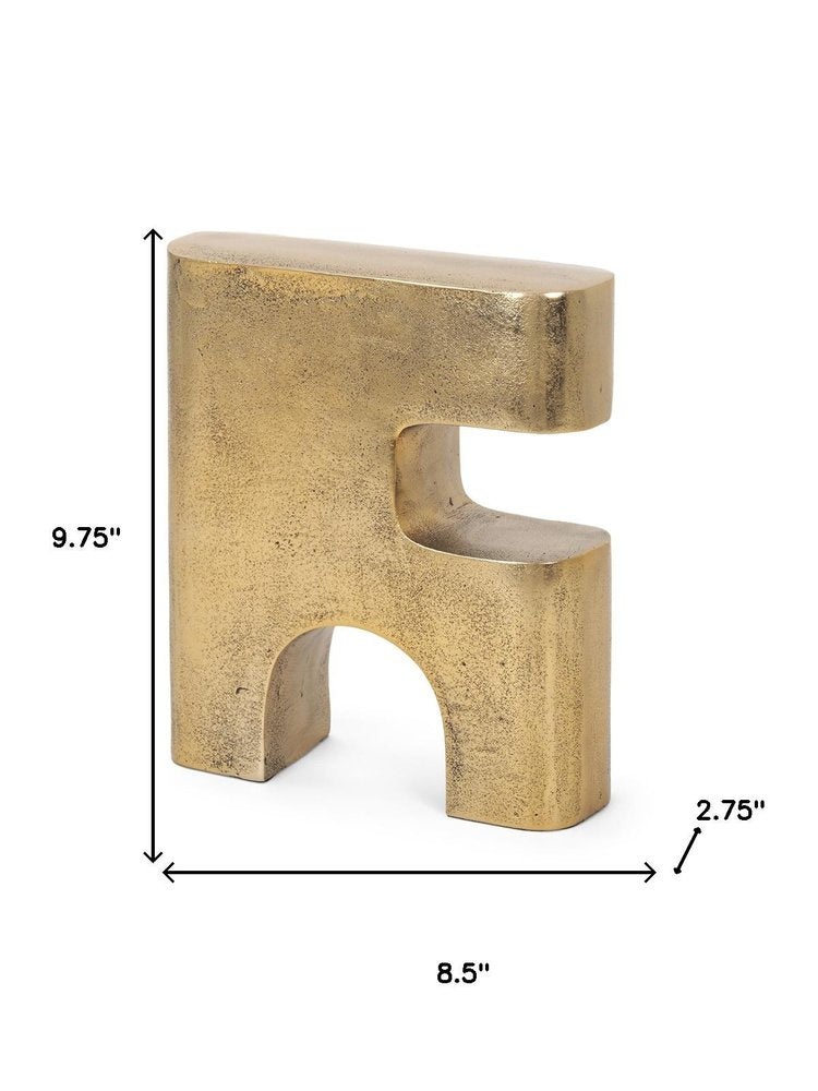 10" Brass Aluminum Tabletop Sculpture. Sculpture isolated on a plain white background, showing a metal surface.