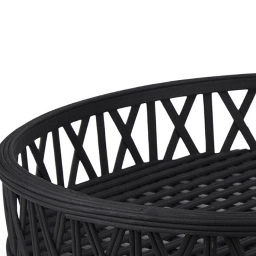 Close-up of a black round wicker serving tray with a criss-cross pattern on the base and a decorative edge.