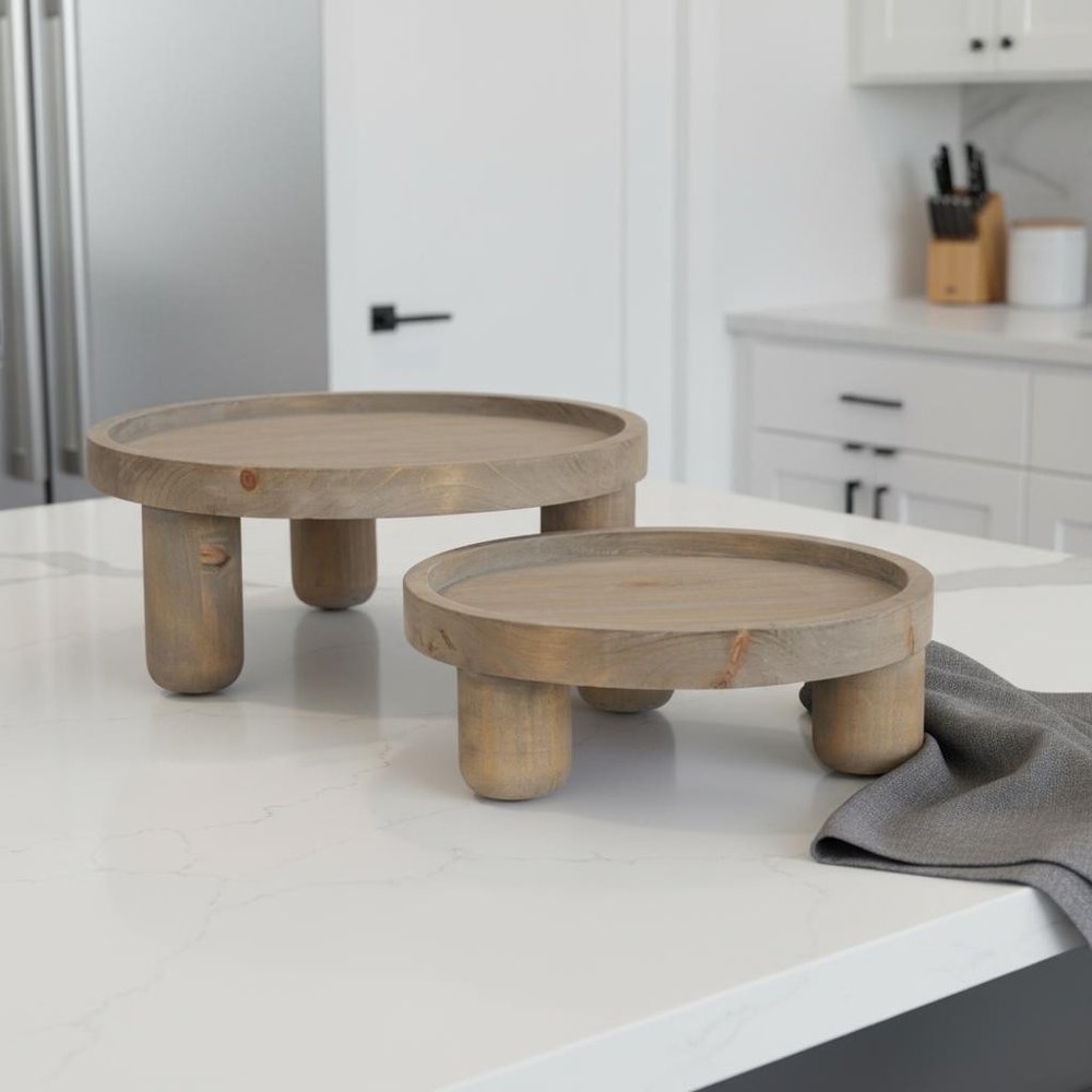 Set of Two Gray And Natural Solid Wood Handmade Round Risers in a home interior