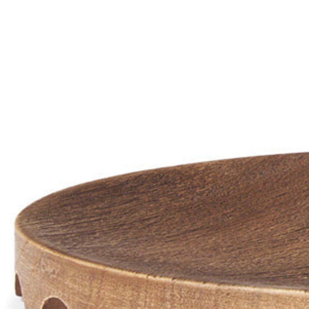 Close-up of a round, natural light brown, handmade wood serving tray with visible wood grain.