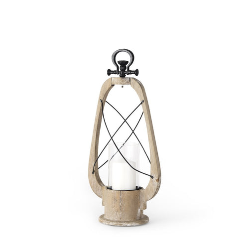 A distressed wood and black metal tabletop lantern with a glass cylinder holding a white candle on a white background.