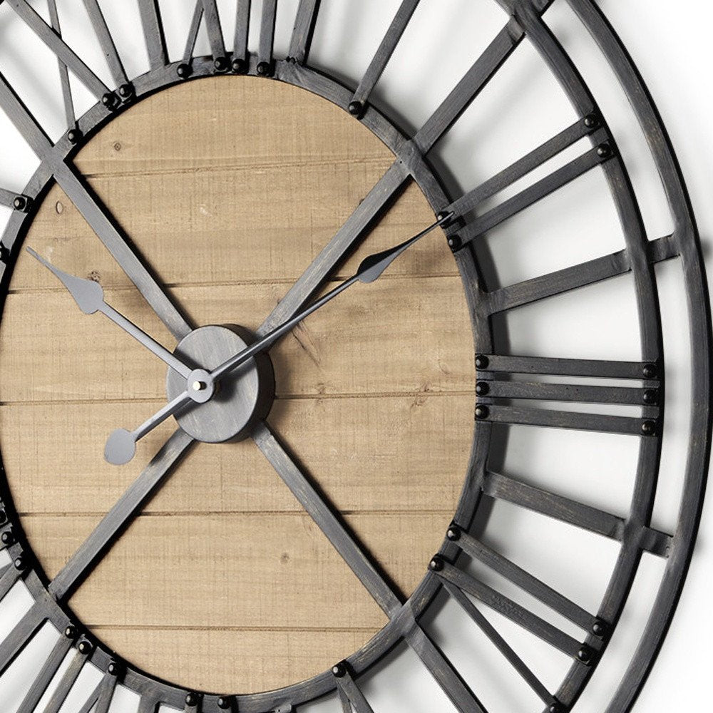 30" Black And Natural Iron And Wood Analog Round Wall Clock detail shot of the black metal finish.