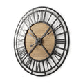 Black and natural iron and wood analog round wall clock with Roman numerals on a white background.