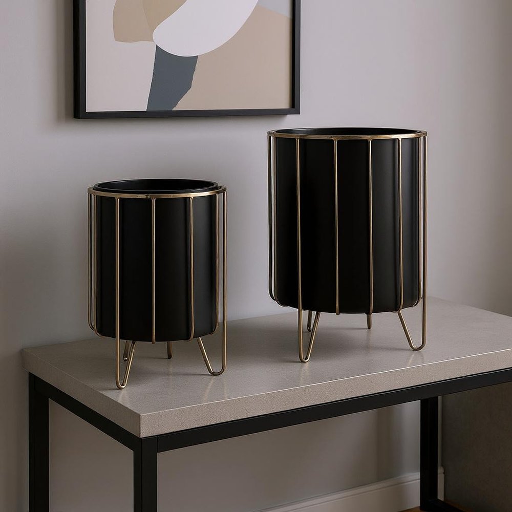 Set of Two Black Metal 20 Ounce Round Pot Planters in a home interior
