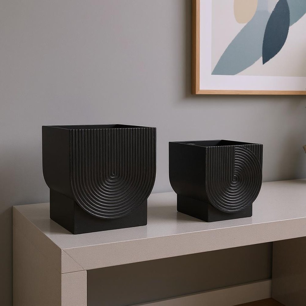 Set of Two Black Metal 20 Ounce Pot Planters in a home interior
