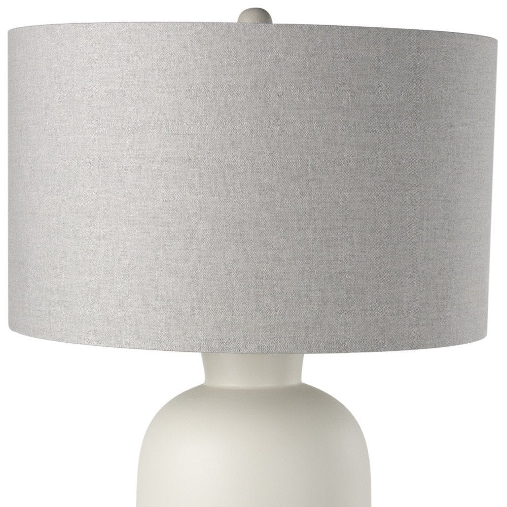 33" Cream Round Bedside Lamp With Drum Shade. Lamp isolated on a plain white background, showing its cream color.