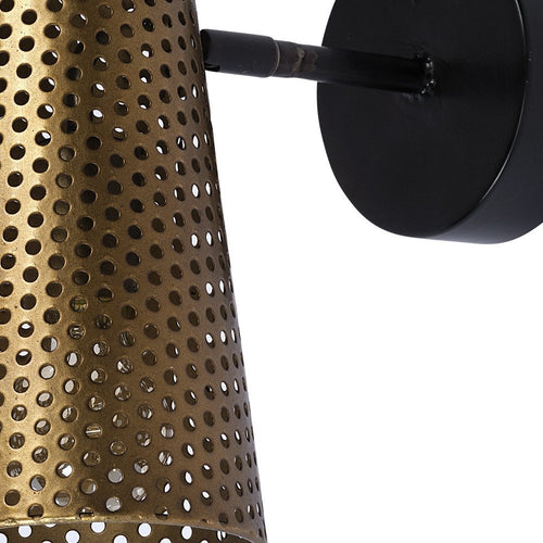 Close-up of an antiqued gold metal pierced cone armed sconce with a black base against a white background.