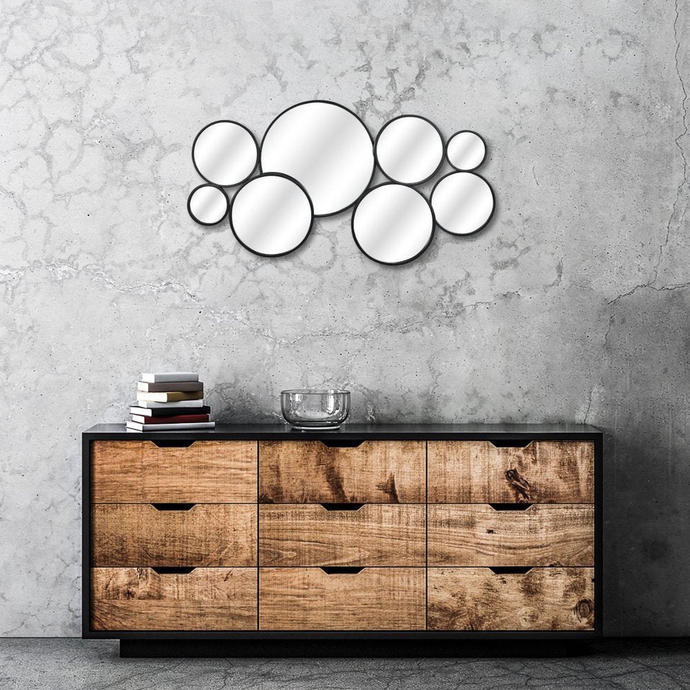 Set Of Eight Black Metal Round Cojoined Accent Mirrors in a home interior