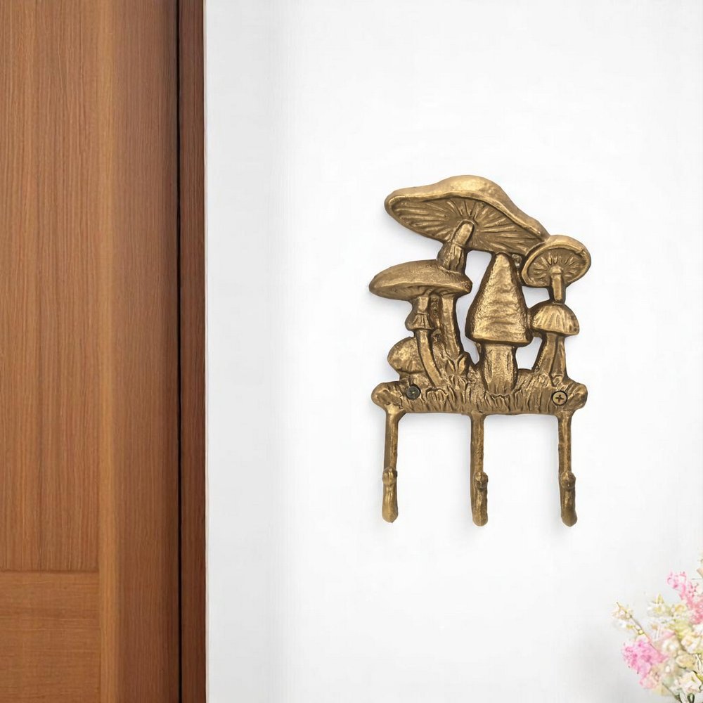 5" Antiqued Gold Cast Iron Mushroom Three Hook Wall Mount Coat Rack. Coat hanger in gold metal.