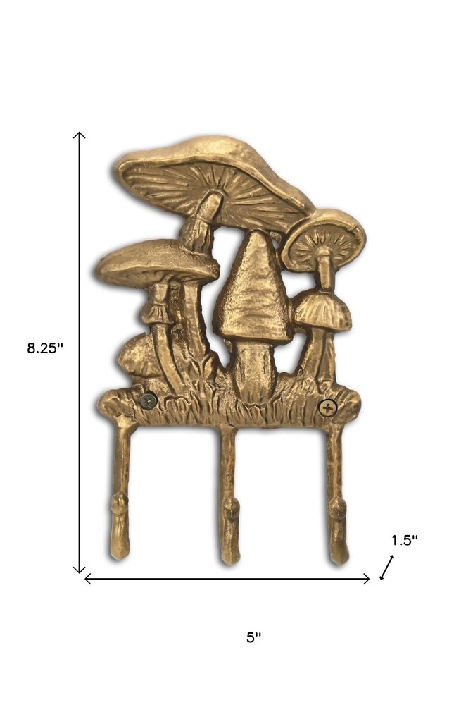 5" Antiqued Gold Cast Iron Mushroom Three Hook Wall Mount Coat Rack. Coat hanger isolated on a plain white background, finished in gold metal.