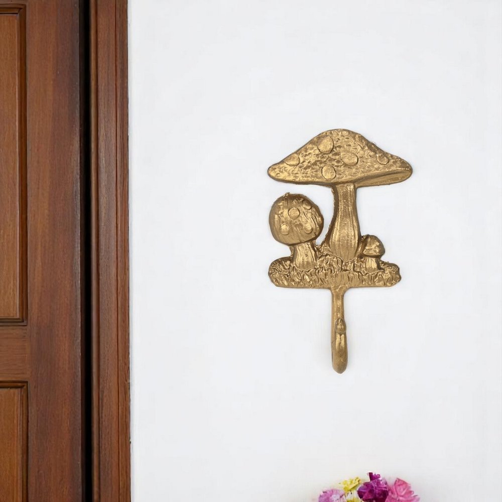 4" Gold Cast Iron Mushroom Wall Hook. Coat hanger isolated on a plain white background, showing a gold metal surface.