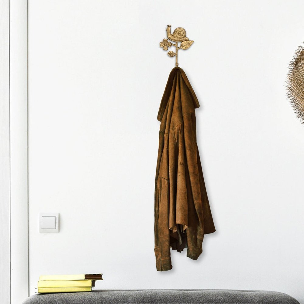 5" Gold Cast Iron Snail Wall Hook. Coat hanger isolated on a plain white background, showing a metal surface.