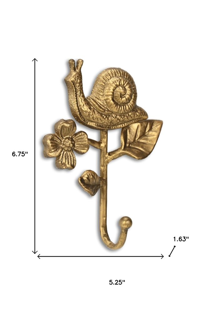 5" Gold Cast Iron Snail Wall Hook. Coat hanger isolated on a plain white background, finished in gold metal.