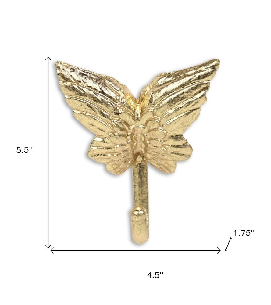 5" Gold Cast Iron Butterfly Wall Hook. Coat hanger isolated on a plain white background, finished in gold metal.