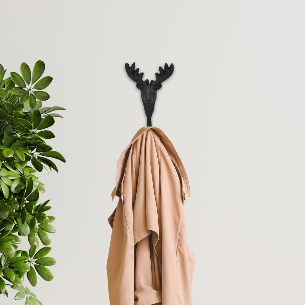 3" Black Cast Iron Deer Stag Wall Hook shown outdoors on an outdoor setting with greenery.