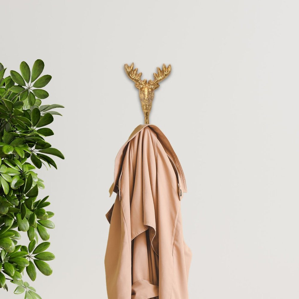 3" Gold Cast Iron Deer Stag Wall Hook shown outdoors on an outdoor setting with greenery.