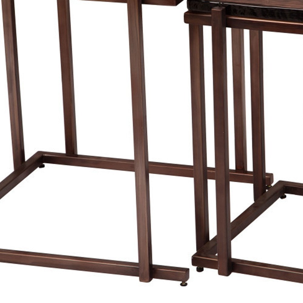 Set of two bronze iron nesting tables with square frames and dark tops, shown against a white background.