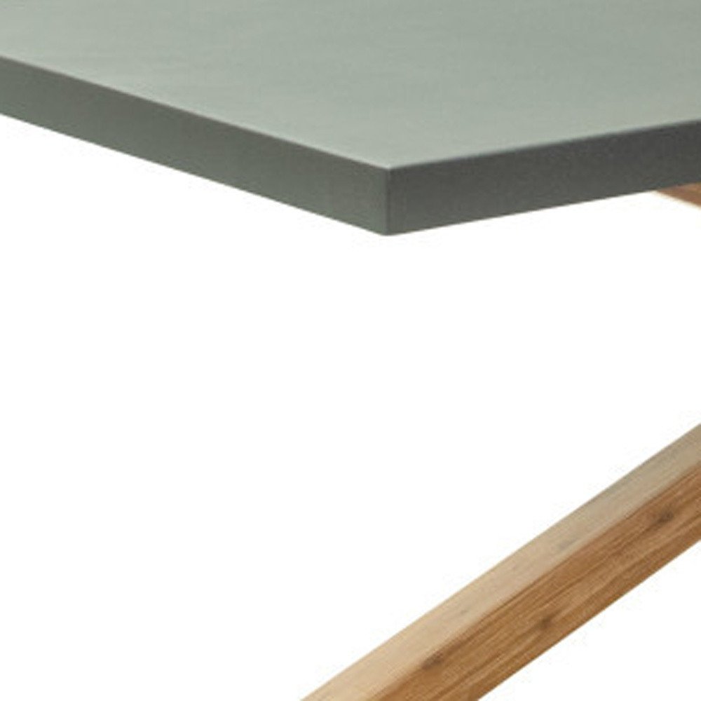 Close-up of a gray faux concrete tabletop with a natural wood cross leg base on a white background.